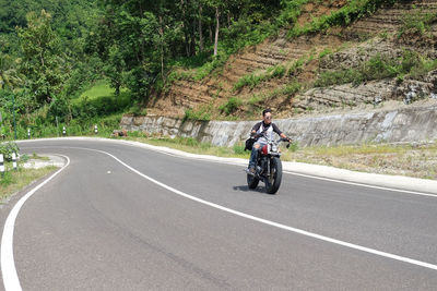 Man riding motorcycle on road