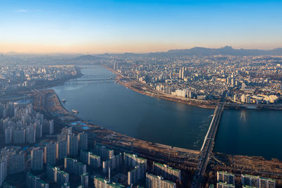 High angle view of river and buildings in city