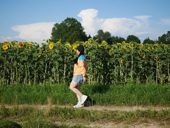 Full length of man standing on field against sky