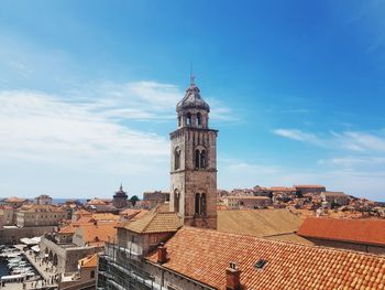 High angle view of clock tower against sky in city