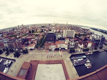 Cityscape against cloudy sky