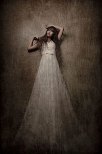 Portrait of a woman standing in the dark