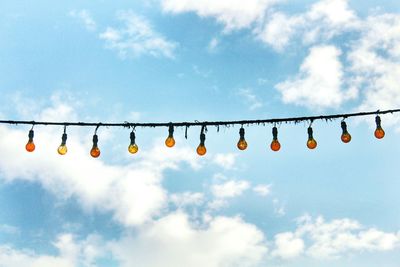 Low angle view of hanging flags against sky