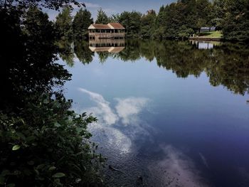 Reflection of trees in lake against sky