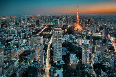 High angle view of illuminated cityscape during sunset