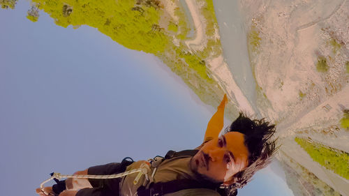 Portrait of man on mountain against sky