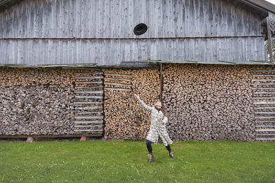 Full length of girl standing by wall