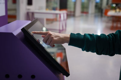 Midsection of man using digital tablet in office