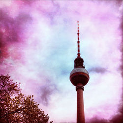 Low angle view of eiffel tower against cloudy sky