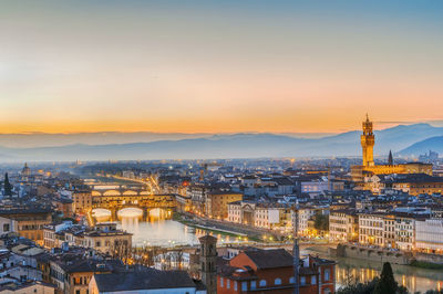 High angle view of illuminated buildings against sky during sunset