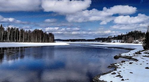Scenic view of sea against cloudy sky