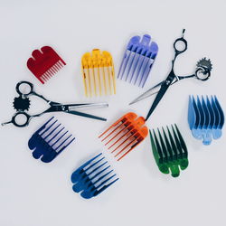 High angle view of umbrellas on table against white background