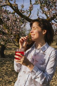 Young woman drinking glass with drink