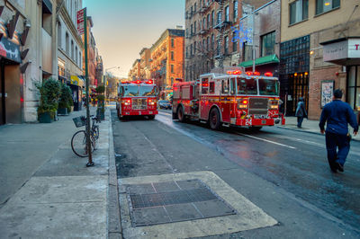 Rear view of man on city street amidst buildings