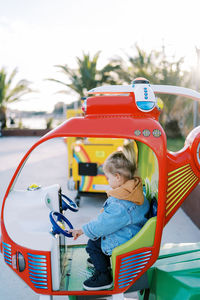 High angle view of boy playing with toy car