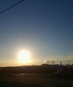 Scenic view of field against clear sky during sunset