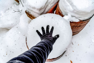 High angle view of human hand holding snow
