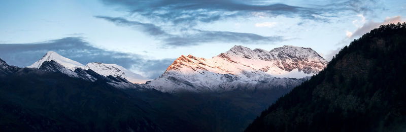 Panoramic view of snowcapped mountains against sky