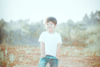 Innocent boy standing on field