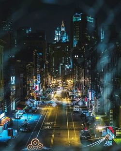 Illuminated cars on road in city at night