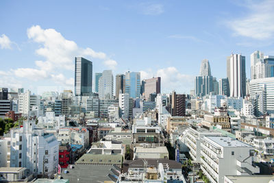 Modern buildings in city against sky