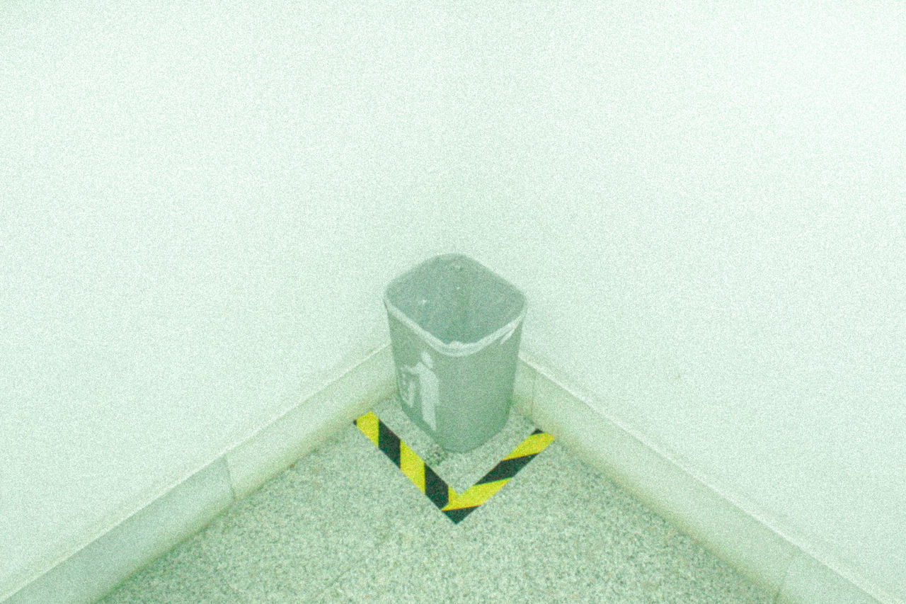 HIGH ANGLE VIEW OF YELLOW PAPER ON WALL