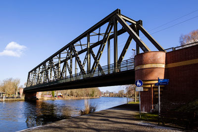Bridge over road against blue sky