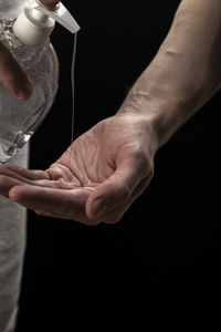 Midsection of man preparing food in glass