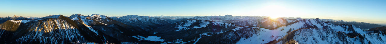 Scenic view of snow covered mountains against sky