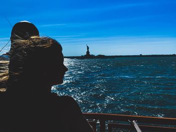 Rear view of silhouette man looking at sea