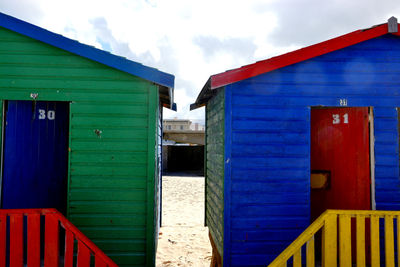 Multi colored houses on building against sky