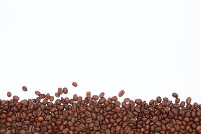 Close-up of coffee beans against white background