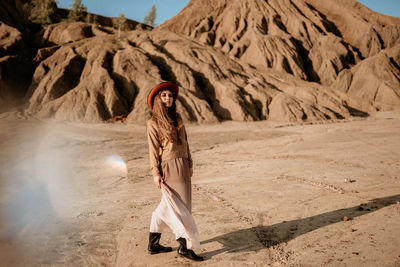 Rear view of woman walk at desert