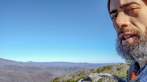 Portrait of man against blue sky