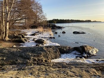 Scenic view of river against sky during winter