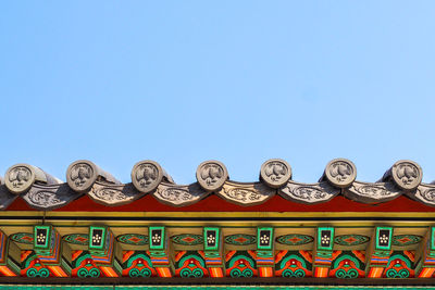 Low angle view of ornate building against clear blue sky