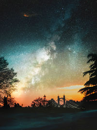 Scenic view of silhouette trees against sky at night