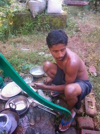 High angle view of young man sitting outdoors