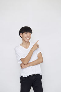 Portrait of smiling man standing against white background