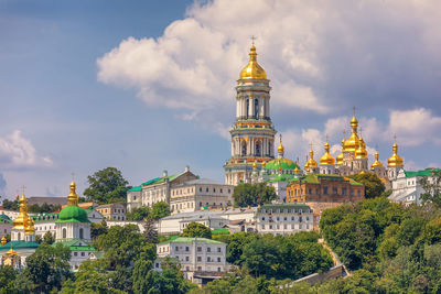 View on kyiv pechersk lavra. lavra belltower, green park and monastic buildings, kyiv. ukraine