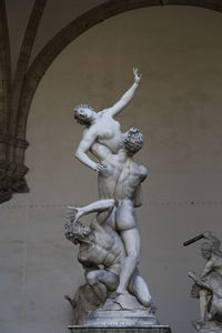 Low angle view of angel statue against wall