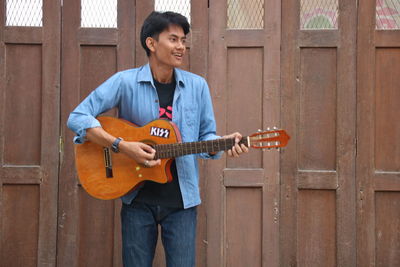 Full length of a man playing guitar