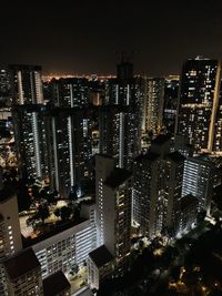 High angle view of illuminated buildings in city at night