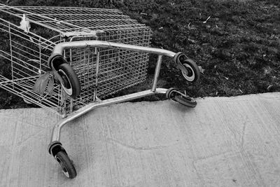 High angle view of fallen shopping cart on footpath