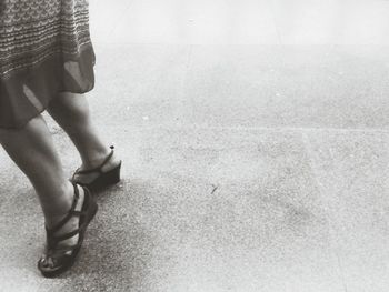 Low section of woman standing on tiled floor