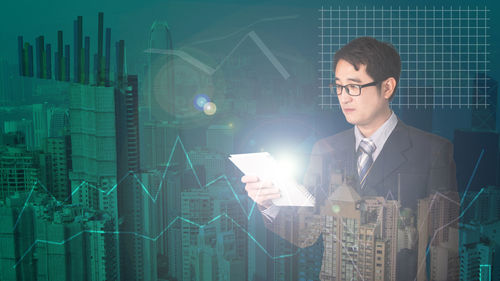 Digital composite image of man holding mobile phone