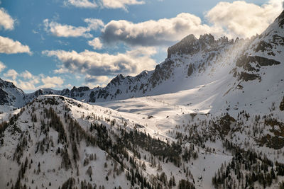 Peaceful rays of the evening sun shine over the ski slopes of the italian dolomites