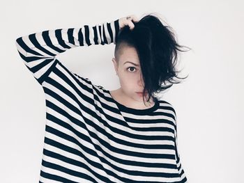 Portrait of woman standing against white background