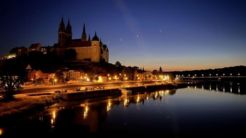 Reflection of illuminated buildings in water at night