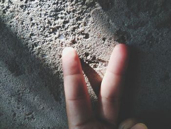 Close-up of hand on wall